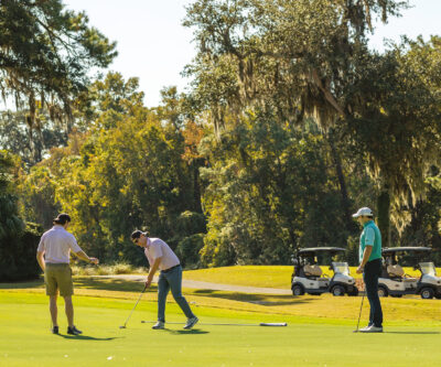 Golfers finishing a round on the first day of the tournament